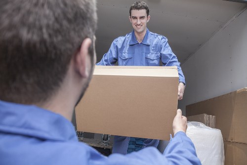 Man and van team loading furniture safely in Ilford